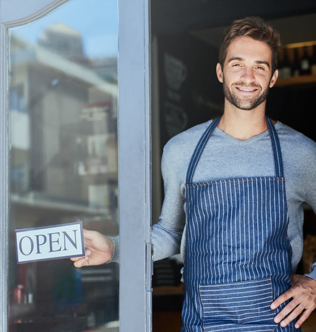A restaurant owner standing at his workplace to engage with customers